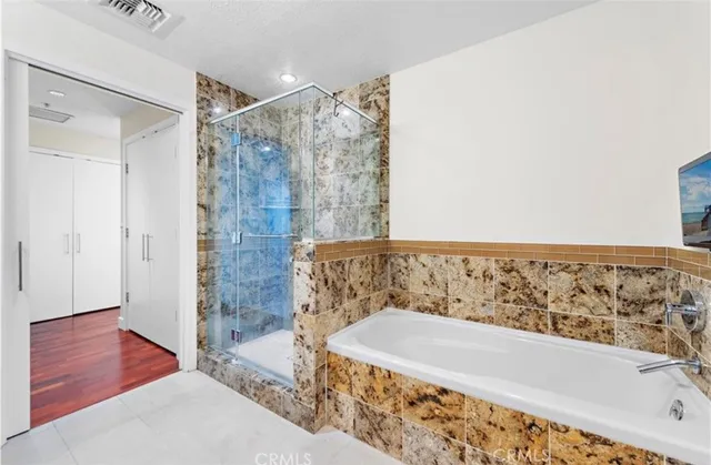 a bathroom with a bathtub and shower