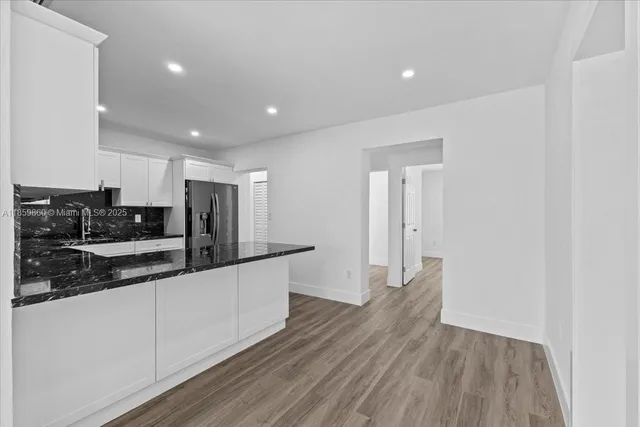 a kitchen with stainless steel appliances a refrigerator and cabinets