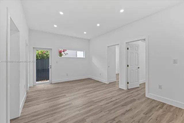 a view of an empty room with wooden floor