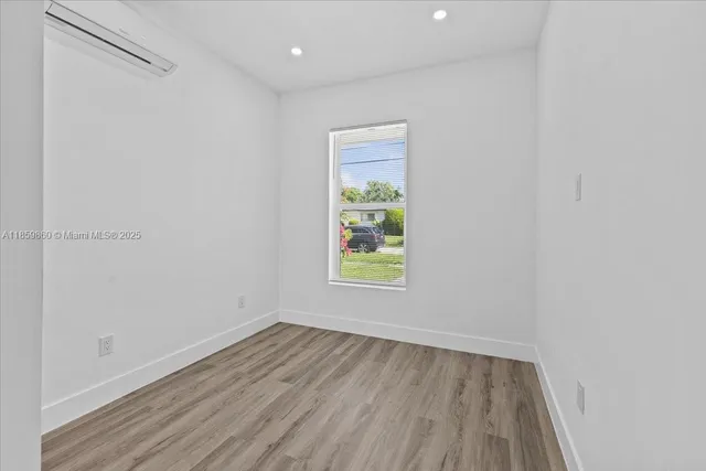 a view of room with window and hardwood floor
