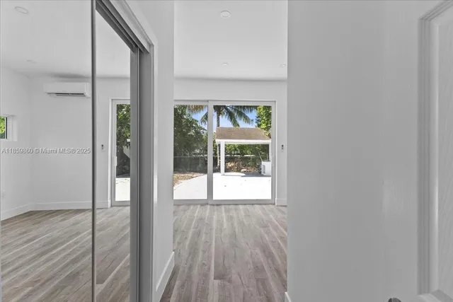 a view of an entryway with wooden floor and door