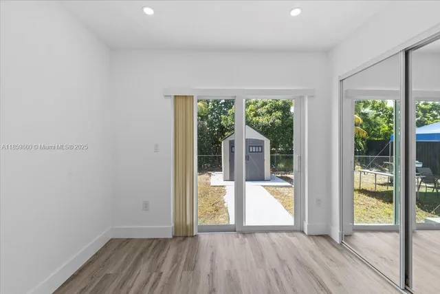 wooden floor in a room next to a window