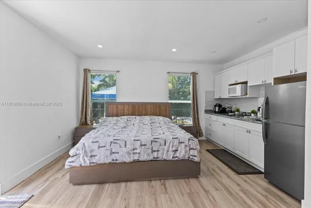 a bedroom with a bed and a large window