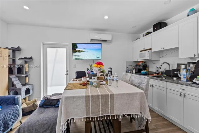 a kitchen with stainless steel appliances dining table and chairs