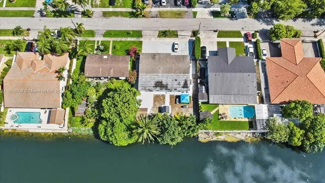 an aerial view of a house with a garden and swimming pool