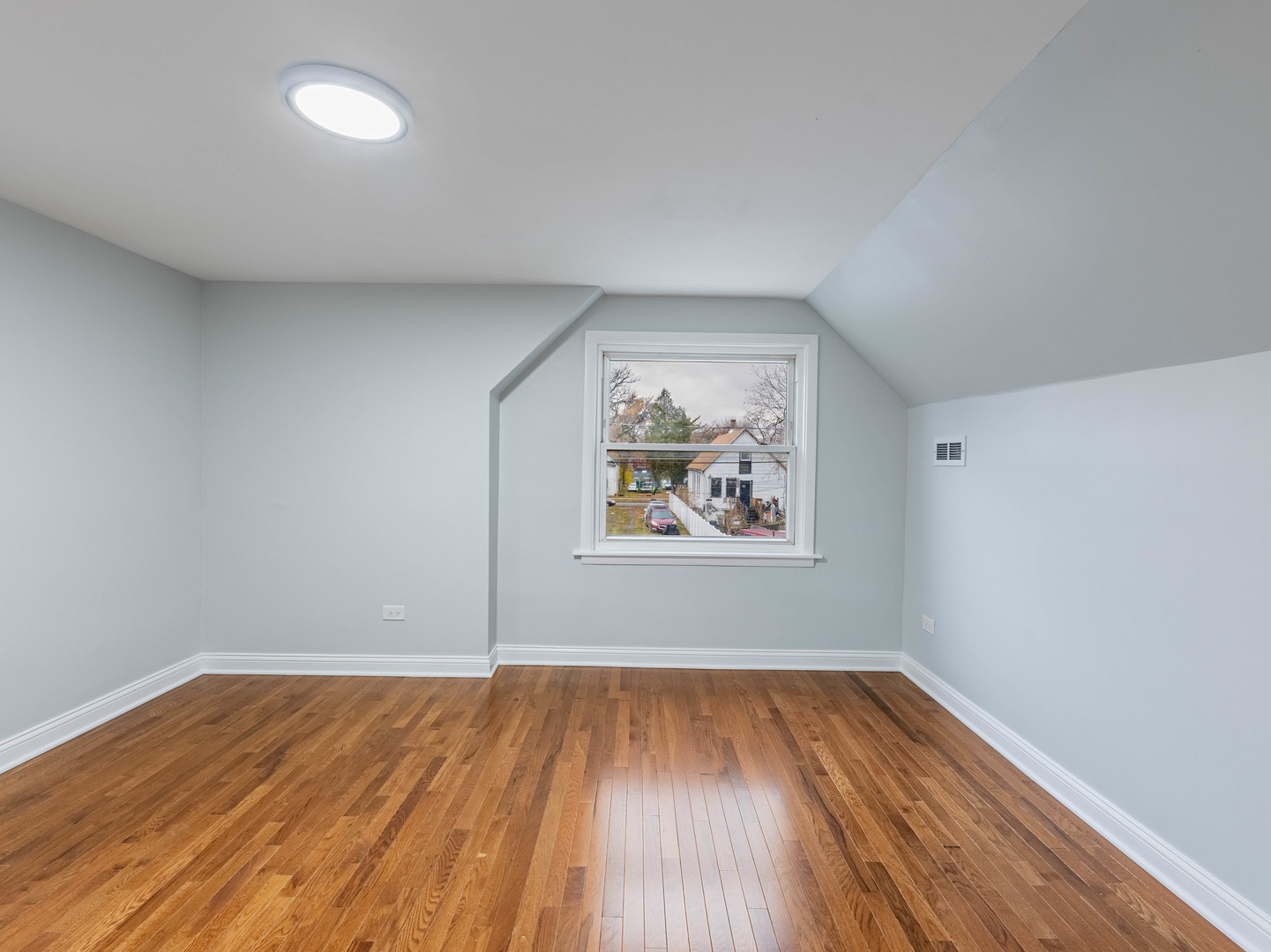 7028 South Honore Street Chicago, IL 60636 - Photo 14 of 18 a view of a room with wooden floors and fan