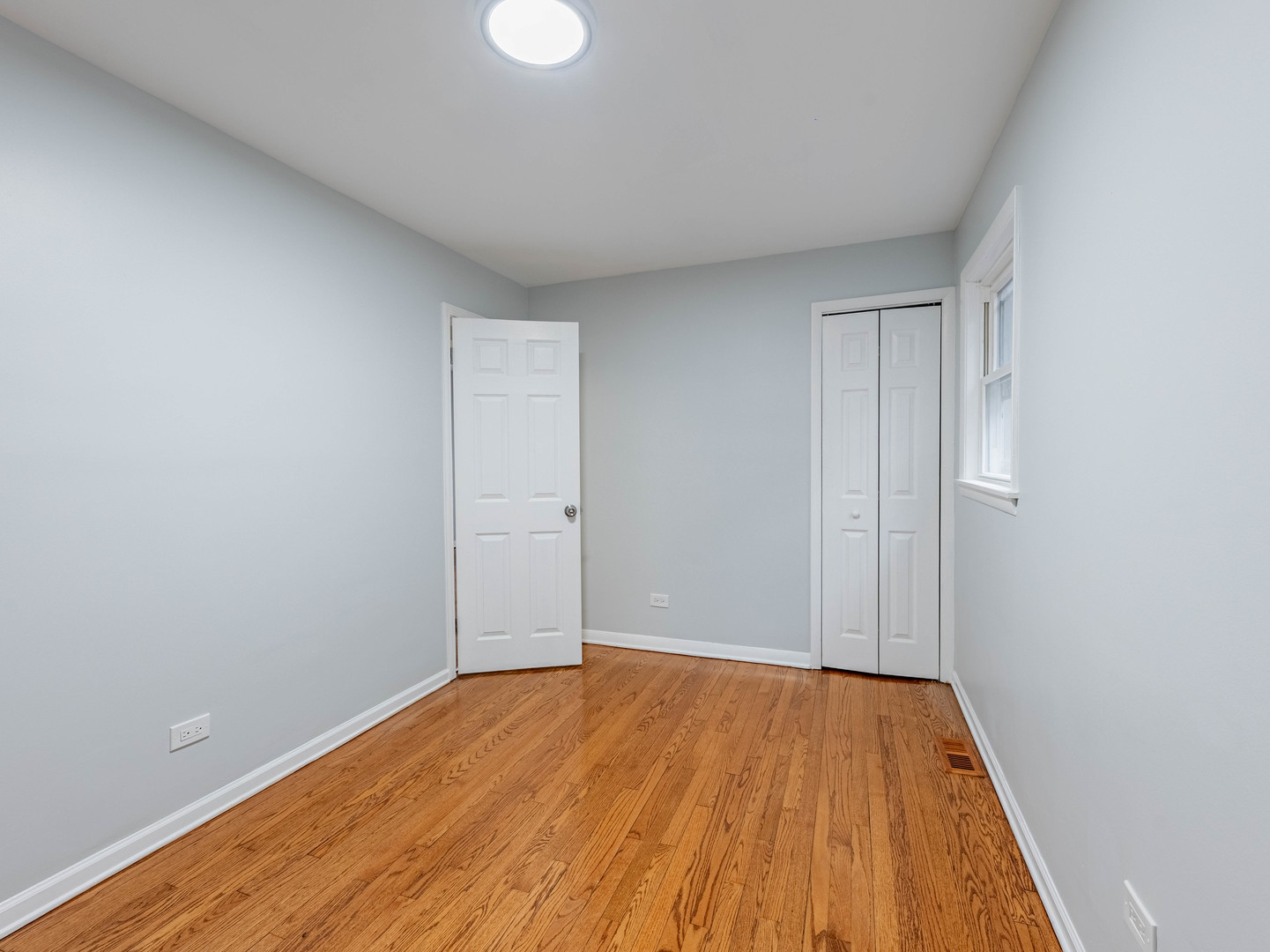 7028 South Honore Street Chicago, IL 60636 - Photo 6 of 18 a view of an empty room with wooden floor