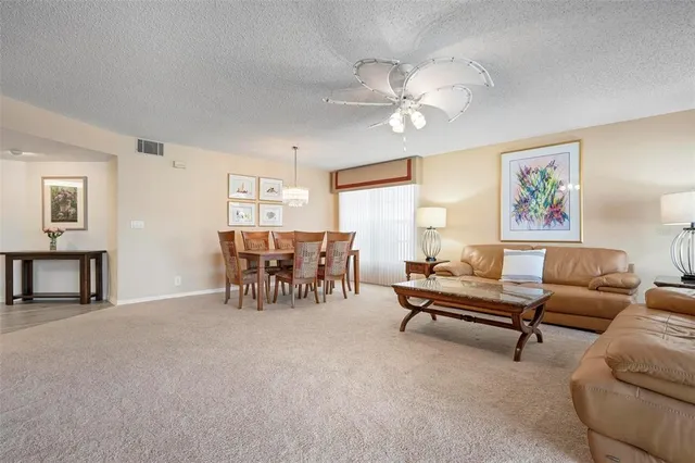 a spacious bedroom with a bed and a lamp