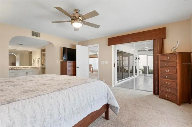 a bathroom with a sink a toilet a mirror and shower