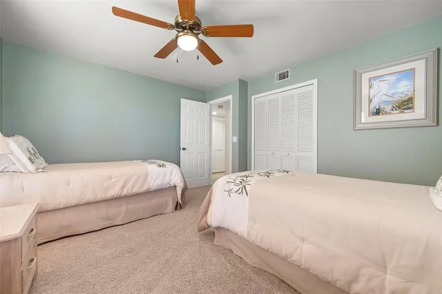 a view of an ocean with boats and trees in the background