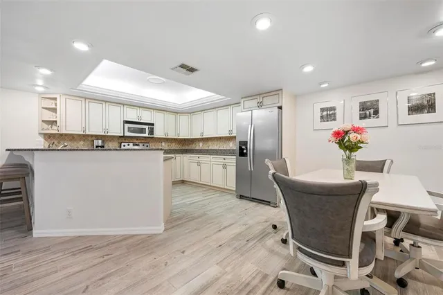 a kitchen with granite countertop a stove top oven sink and cabinets