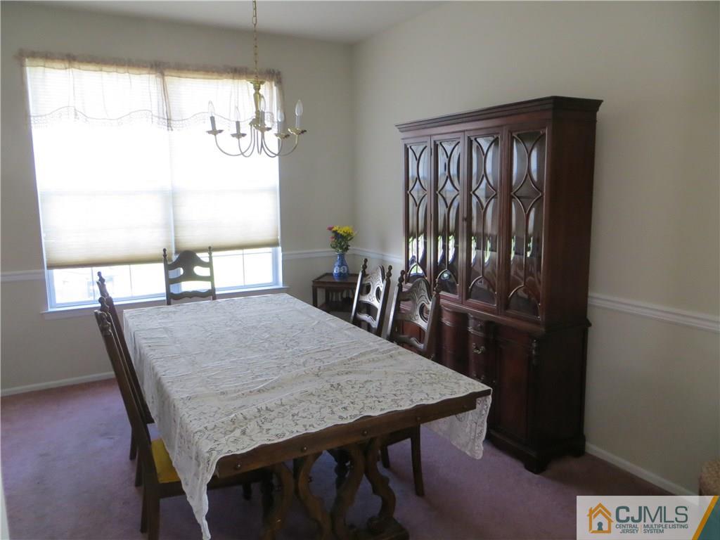 51 Stratton Road Old Bridge, NJ 07747 - Photo 5 of 25 a dining room with a table chairs and chandelier