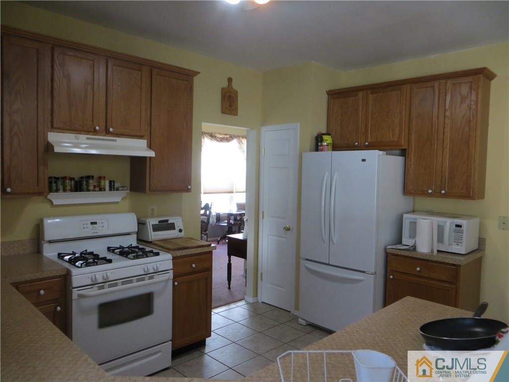 51 Stratton Road Old Bridge, NJ 07747 - Photo 8 of 25 a kitchen with a stove and a refrigerator