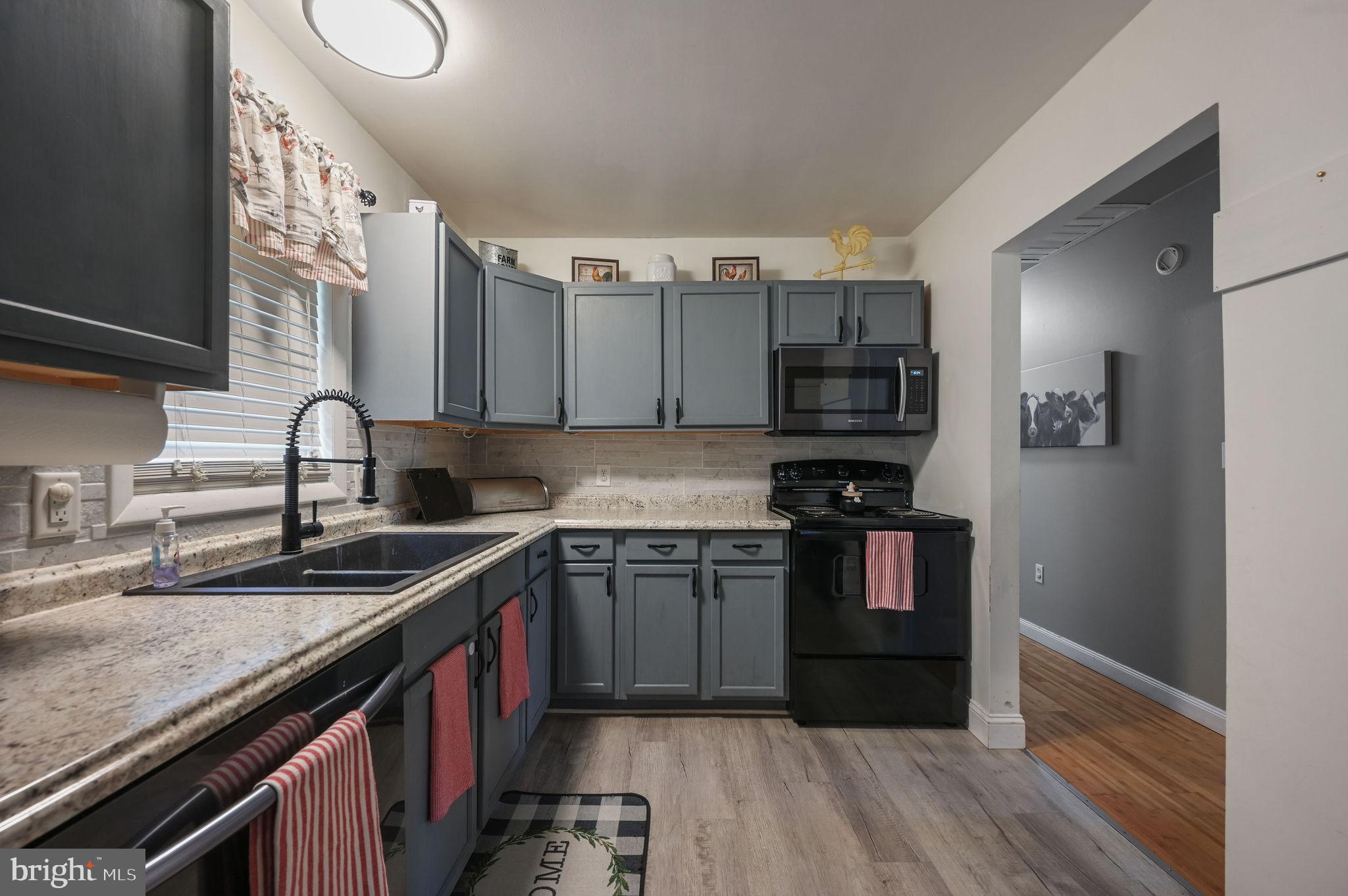 2314 Lockwood Chapel Road Dover, DE 19904 - Photo 11 of 20 a kitchen with stainless steel appliances granite countertop a sink stove and refrigerator