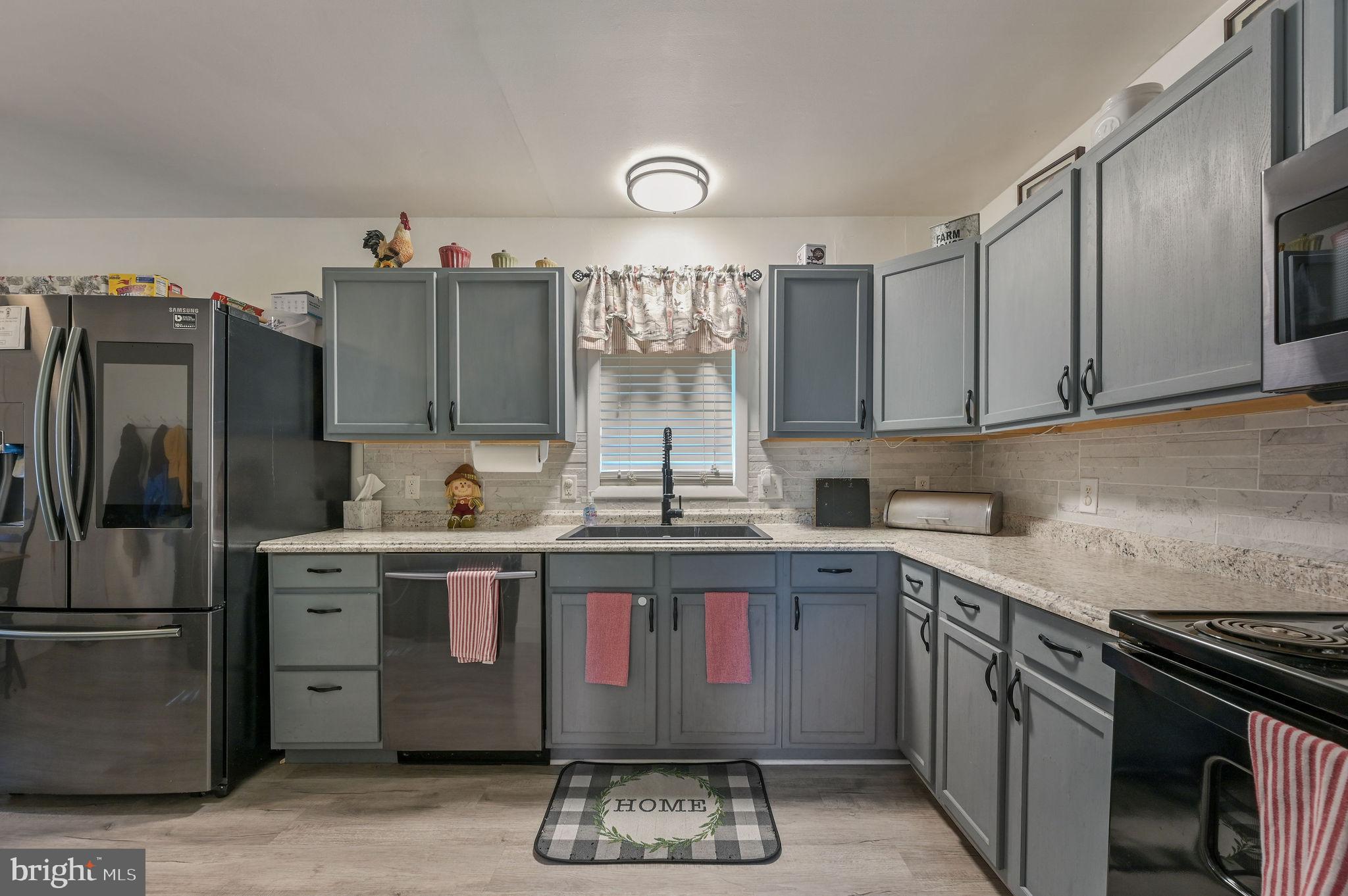2314 Lockwood Chapel Road Dover, DE 19904 - Photo 10 of 20 a kitchen with a sink stove and refrigerator