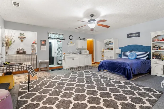 a spacious bedroom with a bed and window