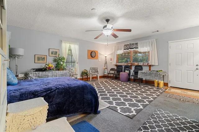 a bedroom with a bed and glass windows