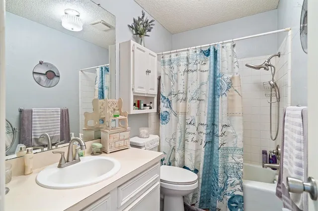 a bathroom with a sink toilet a mirror a vanity and shower