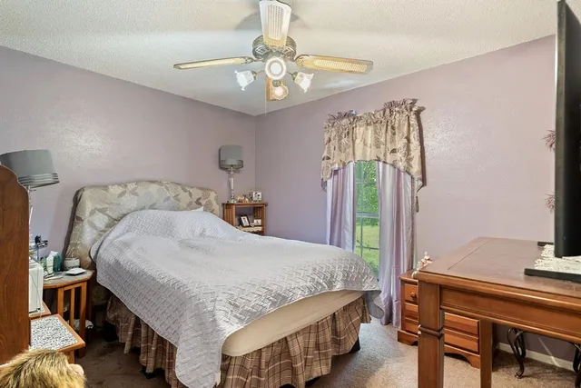 a bedroom with a bed and a table