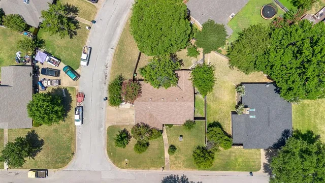 an aerial view of a house with a garden and yard