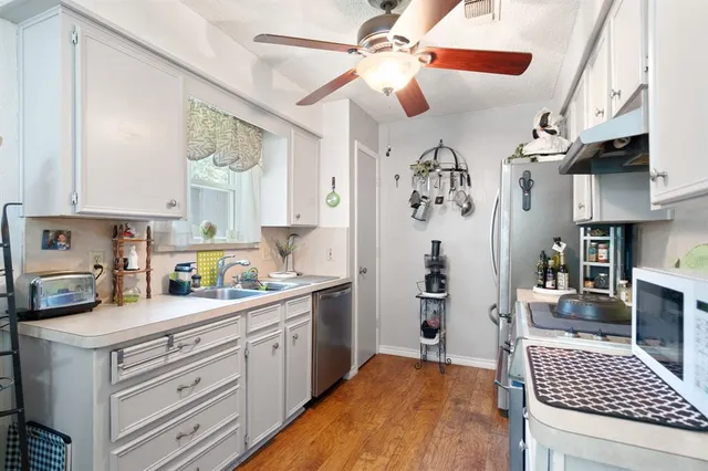 a kitchen with a stove cabinets and window