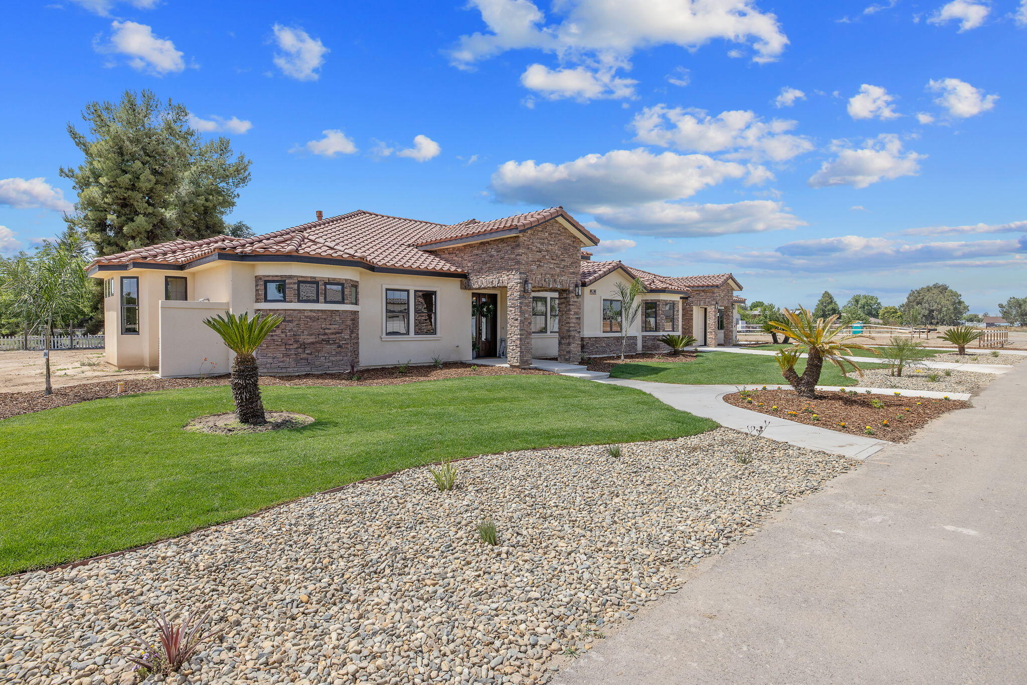503 East Palm Street Exeter, CA 93221 - Photo 2 of 92 a front view of a house with a garden