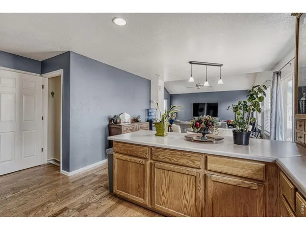 a kitchen with sink cabinets and wooden floor