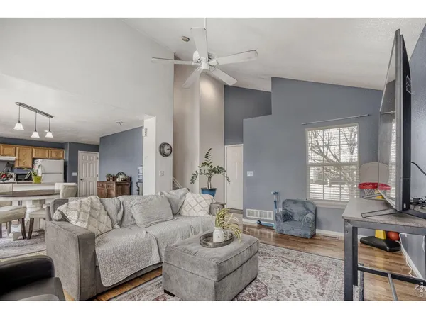 a living room with furniture and wooden floor