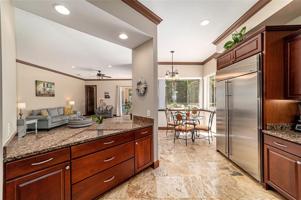 678 Southeast 47th Loop Ocala, FL 34480 - Photo 13 of 73 a kitchen with granite countertop a refrigerator and a sink