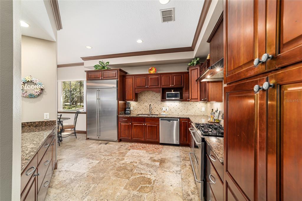 678 Southeast 47th Loop Ocala, FL 34480 - Photo 14 of 73 a kitchen with stainless steel appliances granite countertop a refrigerator and a stove