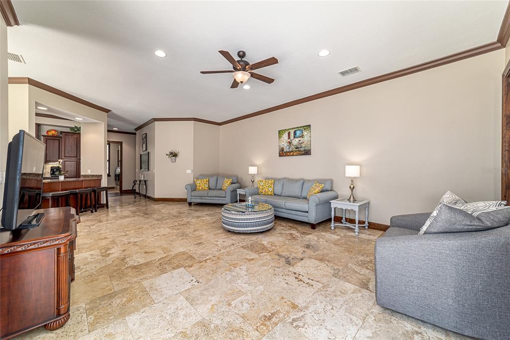 678 Southeast 47th Loop Ocala, FL 34480 - Photo 21 of 73 a living room with furniture and a chandelier
