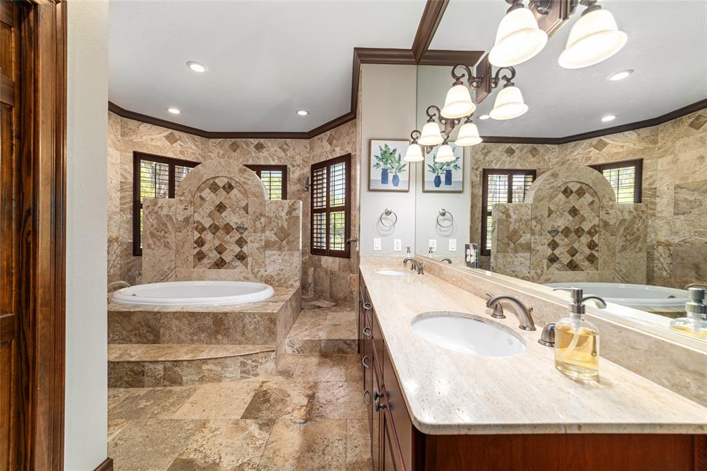 678 Southeast 47th Loop Ocala, FL 34480 - Photo 34 of 73 a bathroom with a granite countertop sink a toilet a mirror and shower