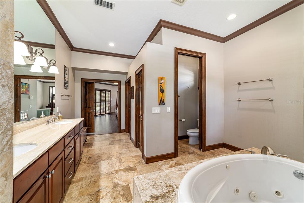 678 Southeast 47th Loop Ocala, FL 34480 - Photo 35 of 73 a bathroom with a tub sink and mirror