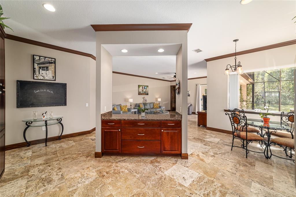 678 Southeast 47th Loop Ocala, FL 34480 - Photo 39 of 73 a living room with furniture a flat screen tv and a large window