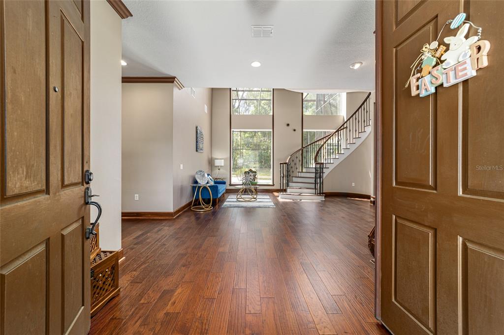 678 Southeast 47th Loop Ocala, FL 34480 - Photo 5 of 73 a view of an entryway with wooden floor and staircase