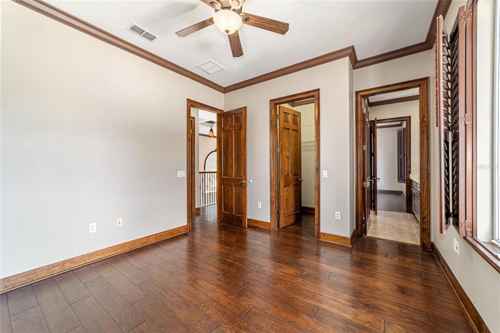 678 Southeast 47th Loop Ocala, FL 34480 - Photo 53 of 73 an empty room with wooden floor and ceiling fan
