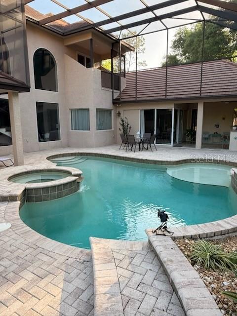 678 Southeast 47th Loop Ocala, FL 34480 - Photo 59 of 73 a front view of a house with a garden and a swimming pool