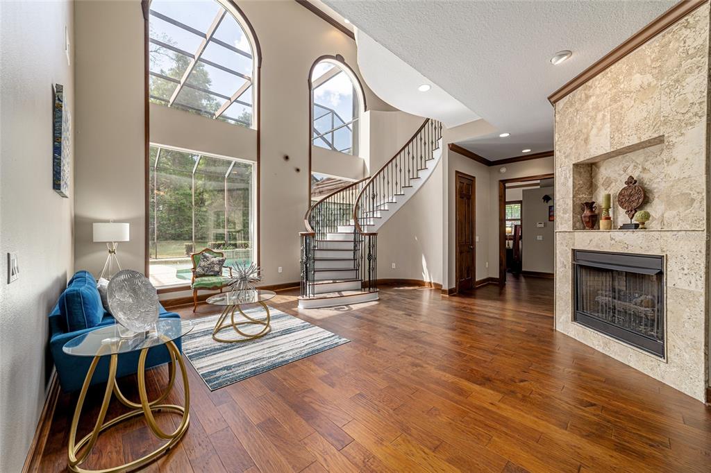 678 Southeast 47th Loop Ocala, FL 34480 - Photo 6 of 73 a living room with fireplace furniture and a wooden floor