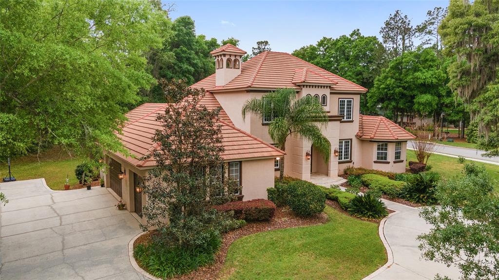 678 Southeast 47th Loop Ocala, FL 34480 - Photo 71 of 73 a front view of a house with a yard and lake view
