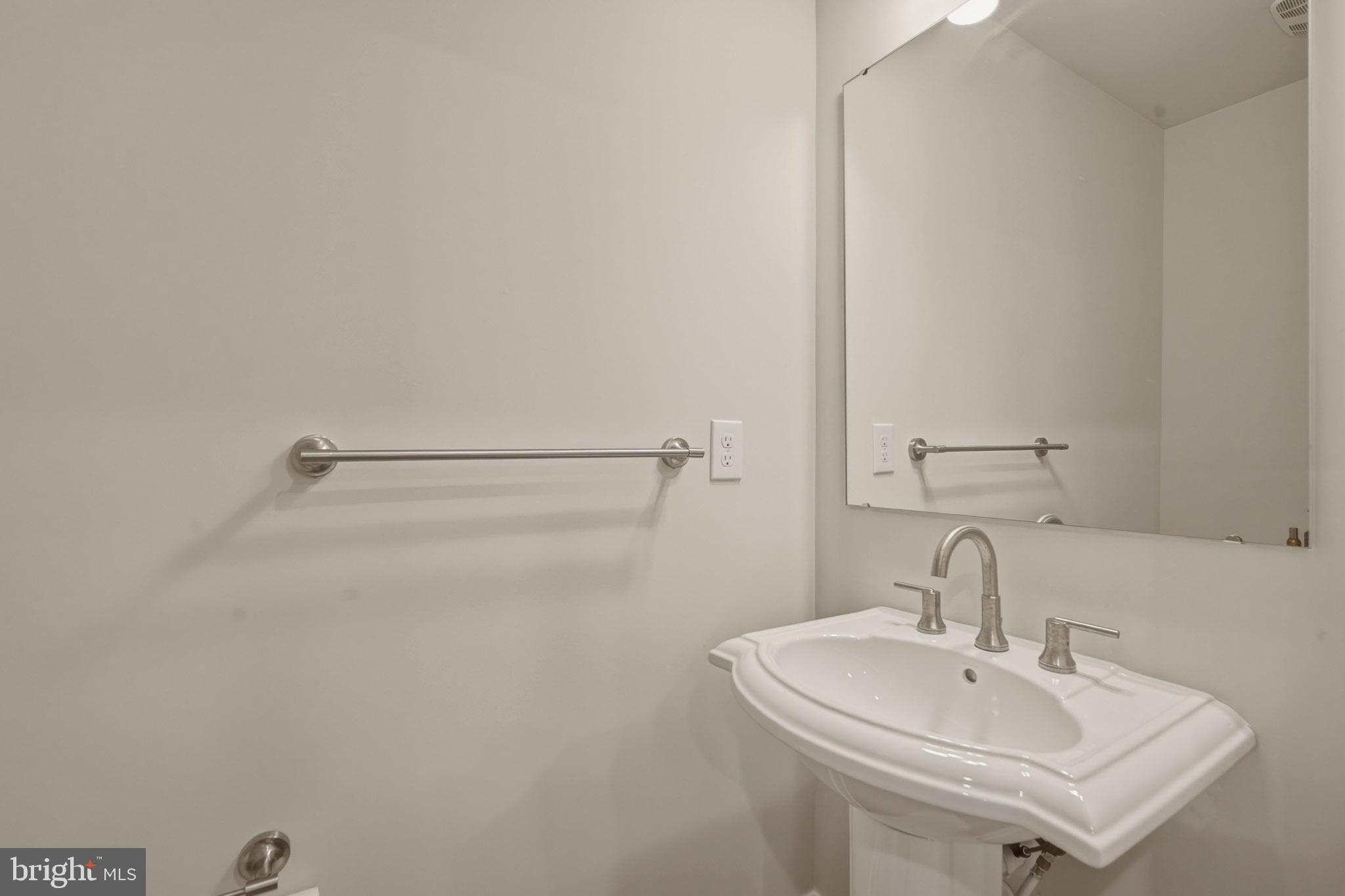 303 Southgate Road Cape May Court House, NJ 08210 - Photo 13 of 25 a bathroom with a sink and a mirror