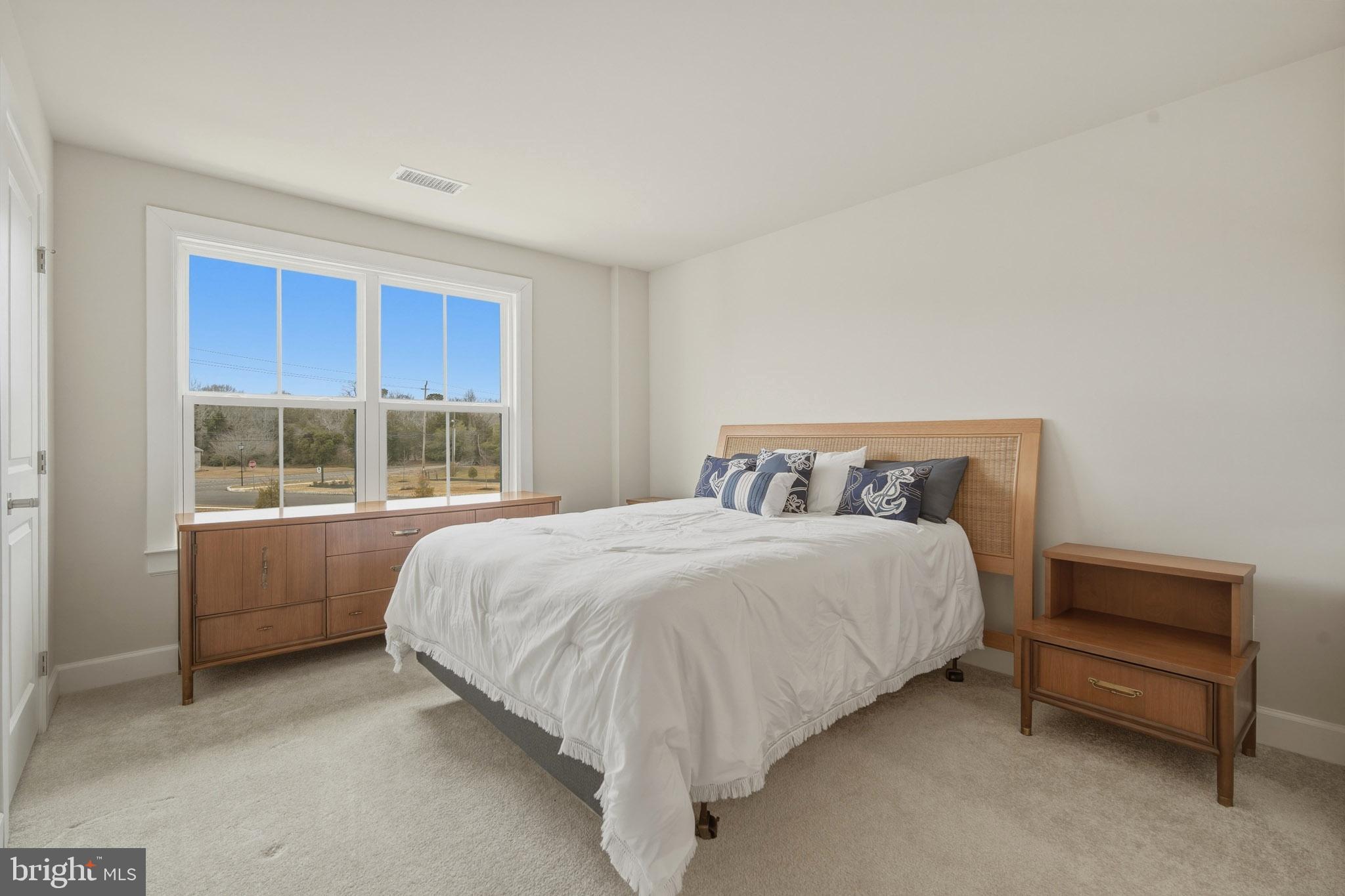 303 Southgate Road Cape May Court House, NJ 08210 - Photo 18 of 25 a bed sitting in a bedroom next to a window