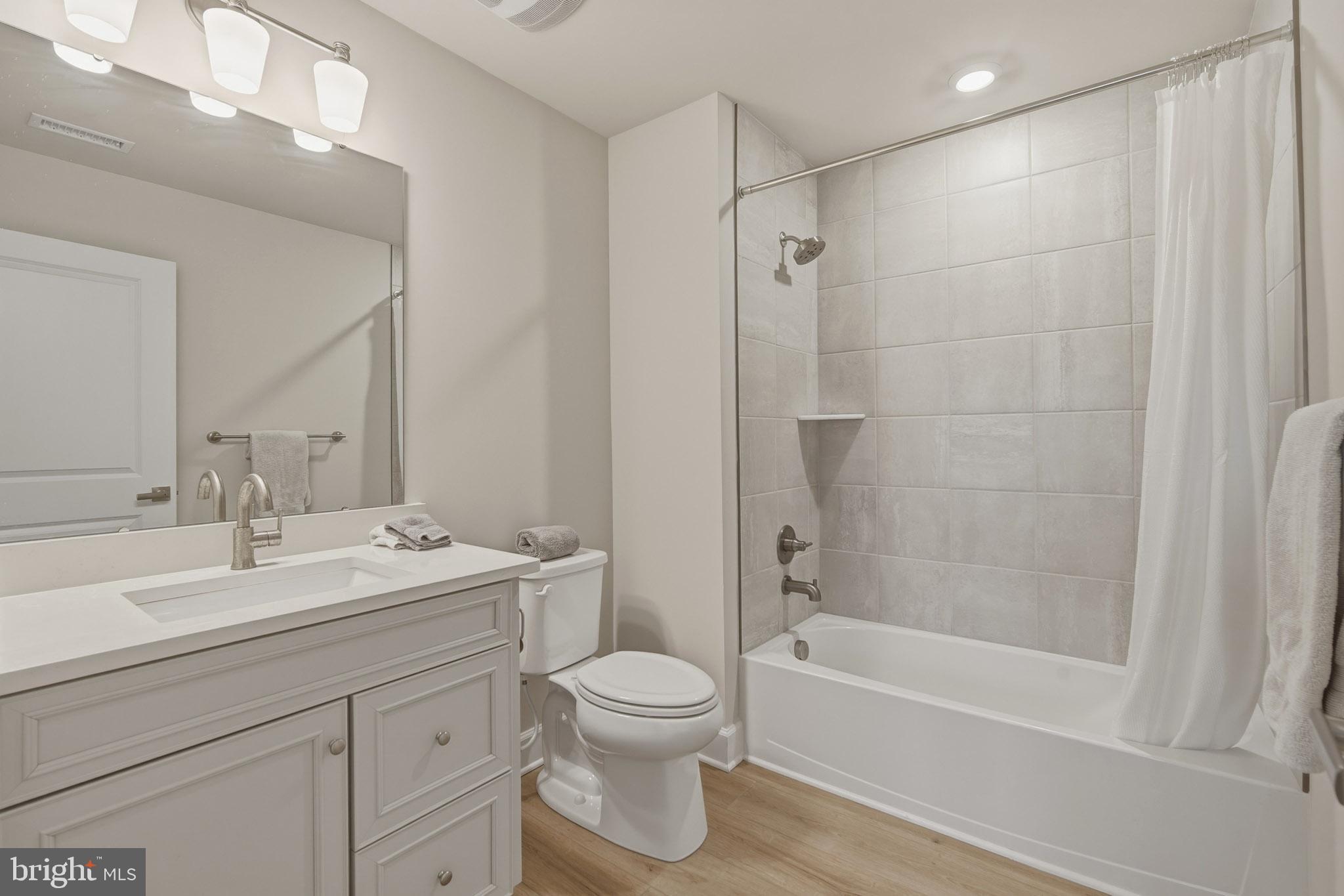 303 Southgate Road Cape May Court House, NJ 08210 - Photo 20 of 25 a bathroom with a toilet a sink a mirror a bathtub and vanity