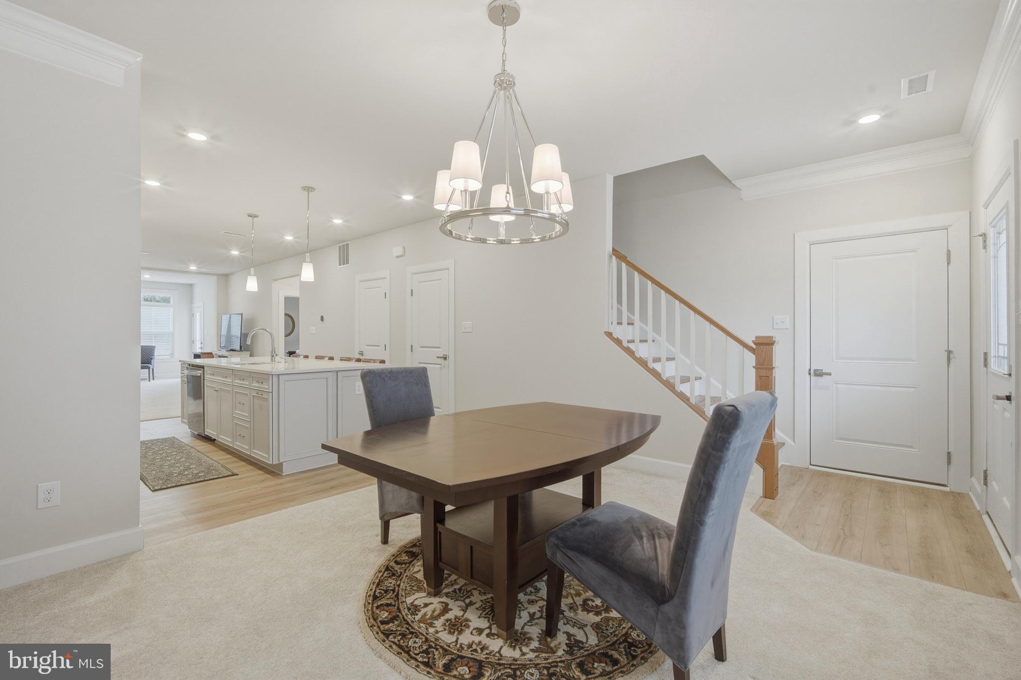 303 Southgate Road Cape May Court House, NJ 08210 - Photo 2 of 25 a dining room with wooden floor a chandelier a glass table and chairs