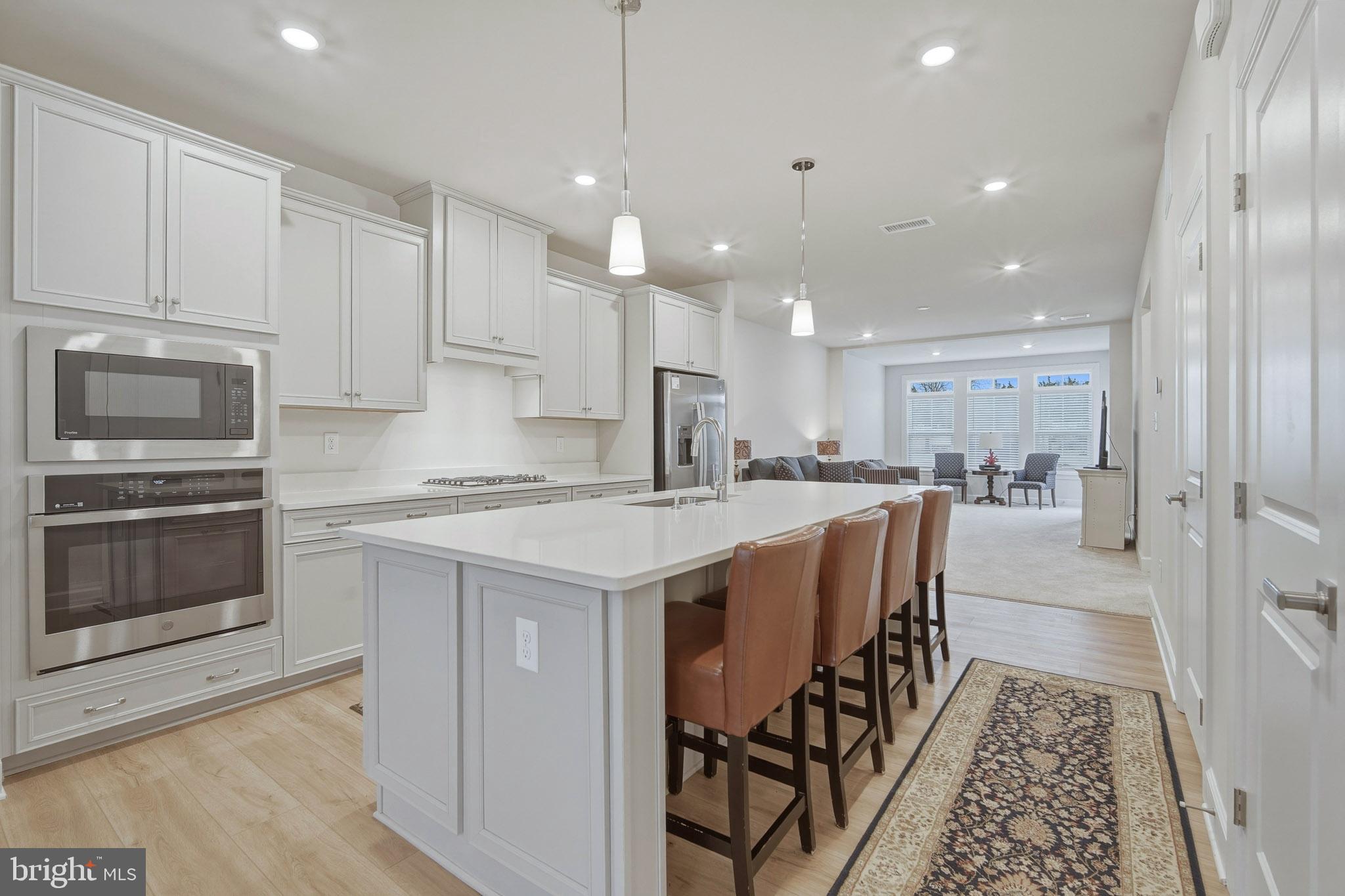 303 Southgate Road Cape May Court House, NJ 08210 - Photo 3 of 25 a kitchen with a stove a sink and a refrigerator with wooden floor