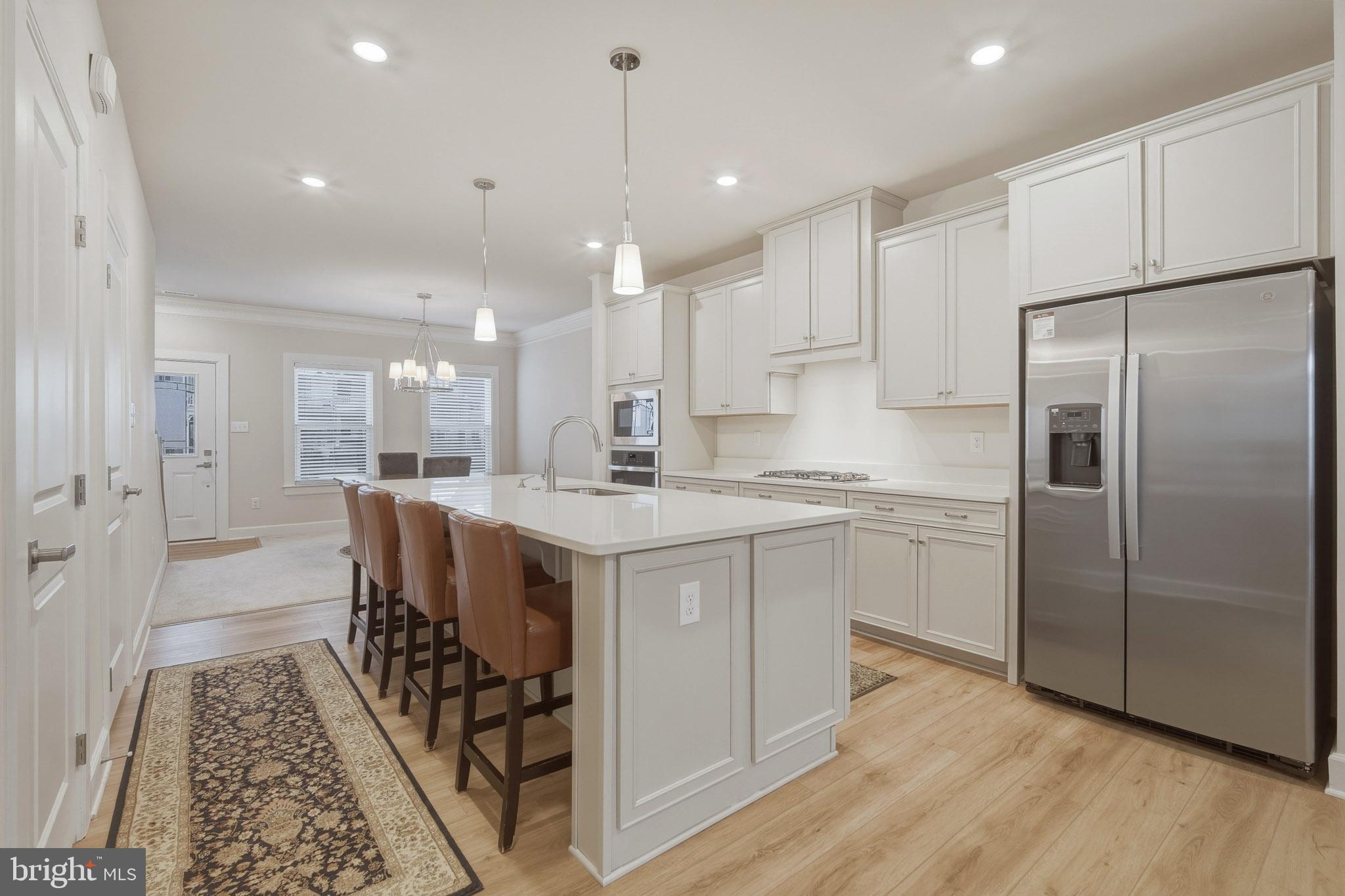 303 Southgate Road Cape May Court House, NJ 08210 - Photo 4 of 25 a kitchen with stainless steel appliances granite countertop a refrigerator a sink dishwasher a stove and white cabinets with wooden floor