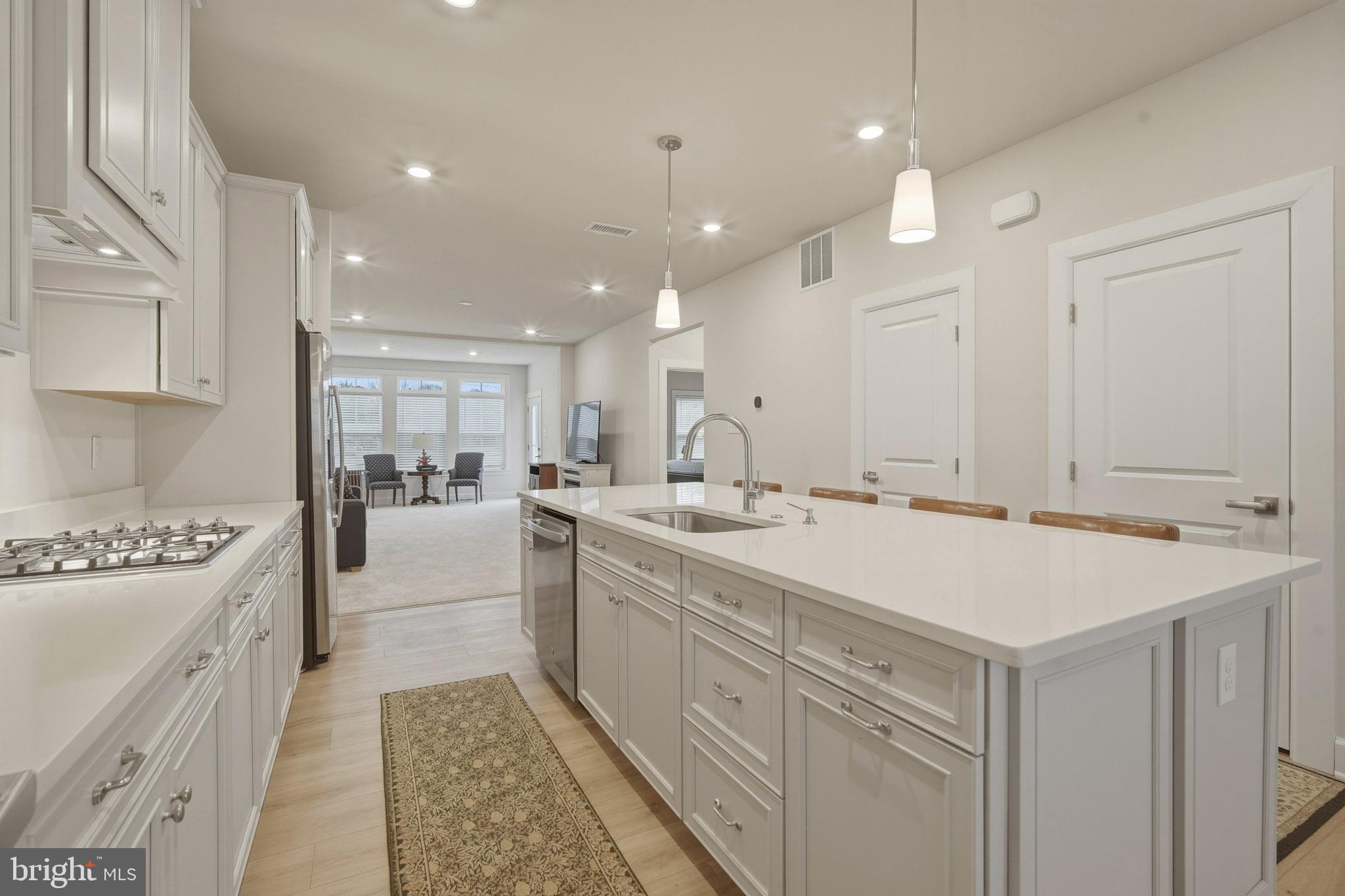 303 Southgate Road Cape May Court House, NJ 08210 - Photo 5 of 25 a large white kitchen with a stove and a sink
