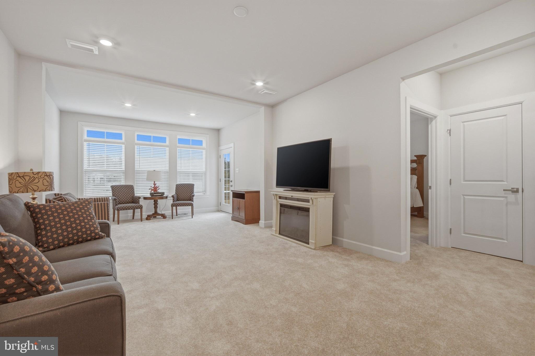 303 Southgate Road Cape May Court House, NJ 08210 - Photo 8 of 25 a living room with furniture and a flat screen tv