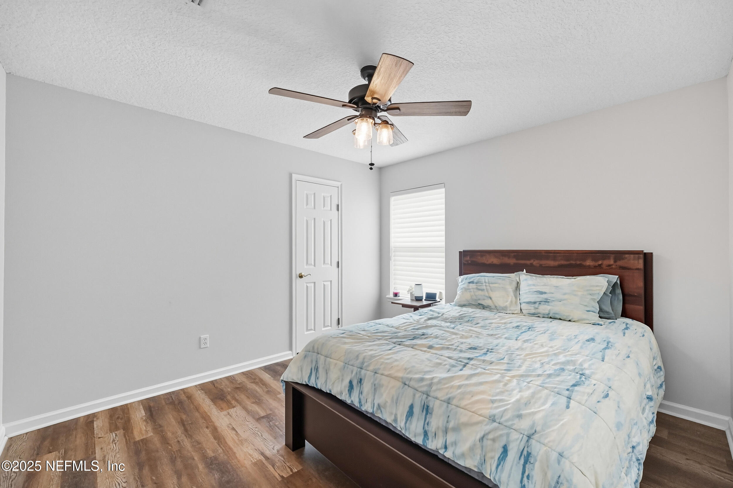 3761 Golden Reeds Lane Jacksonville, FL 32224 - Photo 19 of 40 a bedroom with a bed and a chandelier