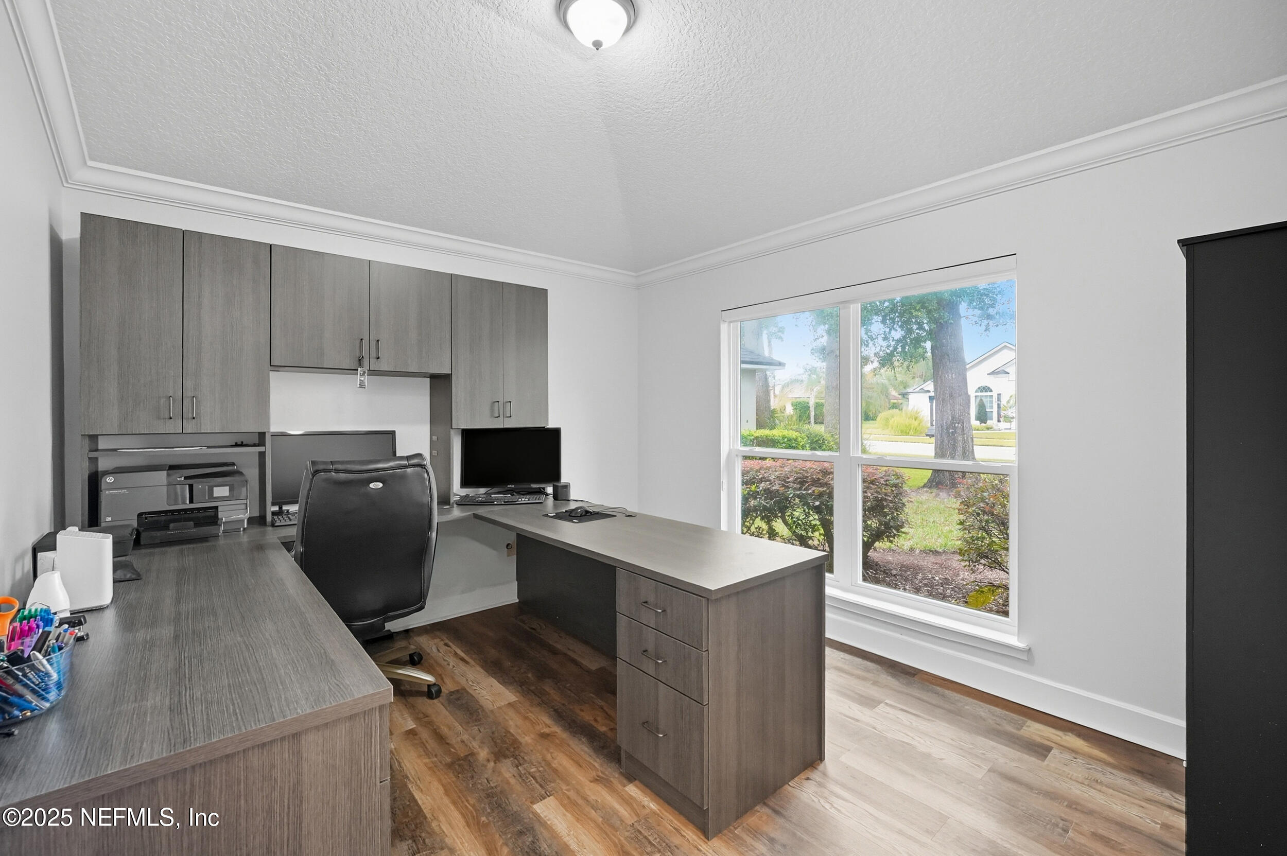 3761 Golden Reeds Lane Jacksonville, FL 32224 - Photo 5 of 40 a kitchen that has a lot of cabinets in it and wooden floors