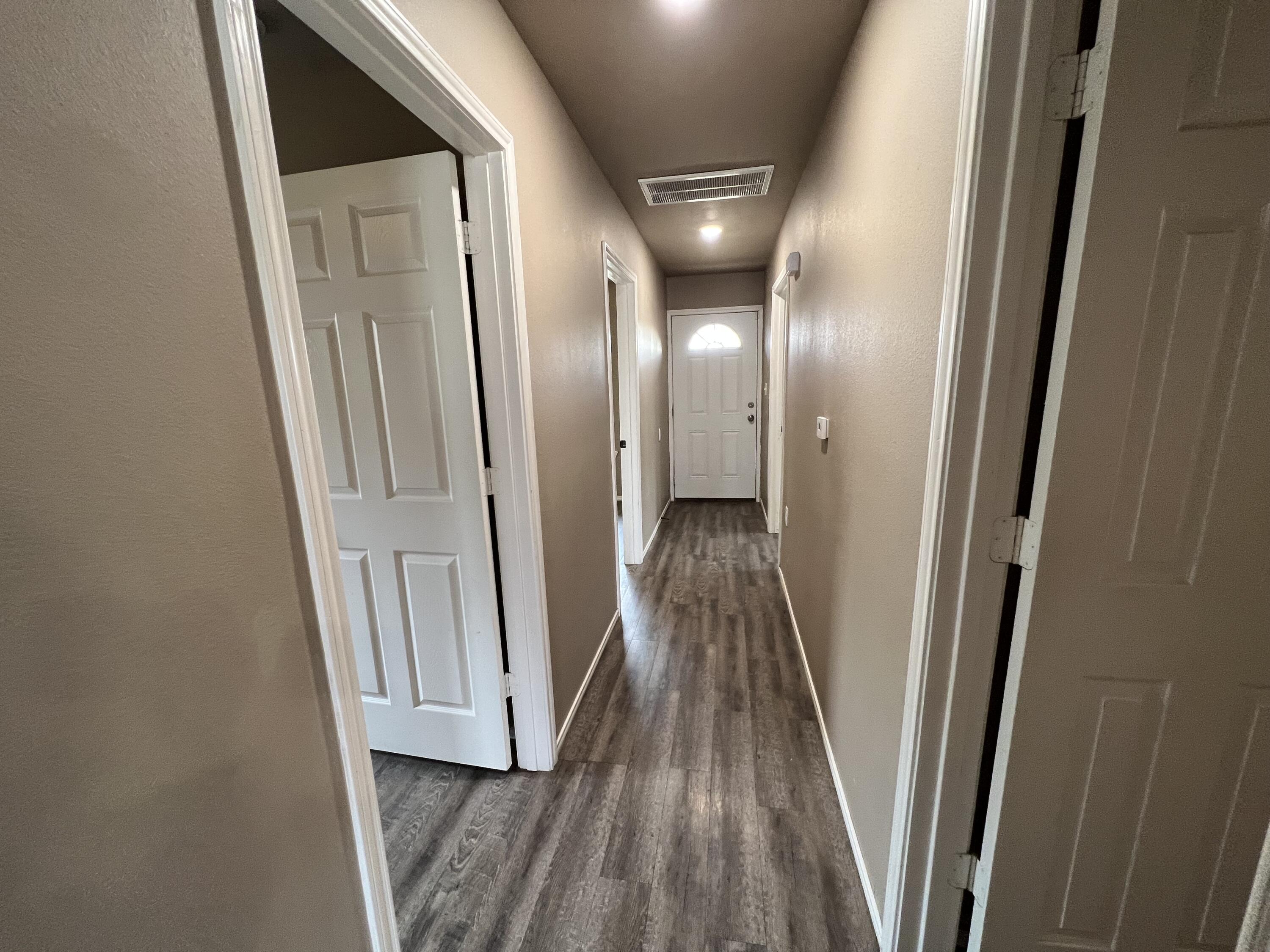 2914 East Cornell Street Lubbock, TX 79403 - Photo 4 of 18 a view of a hallway with wooden floor and staircase
